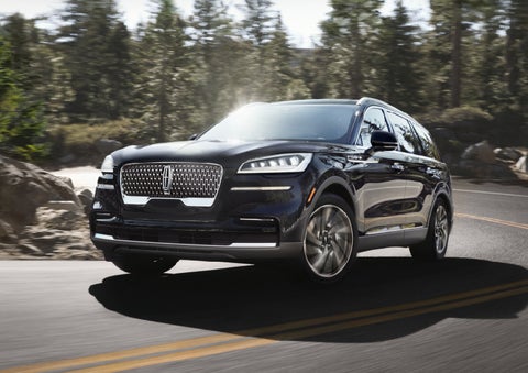 A Lincoln Aviator® SUV is being driven on a winding mountain road | Buss Lincoln in McHenry IL
