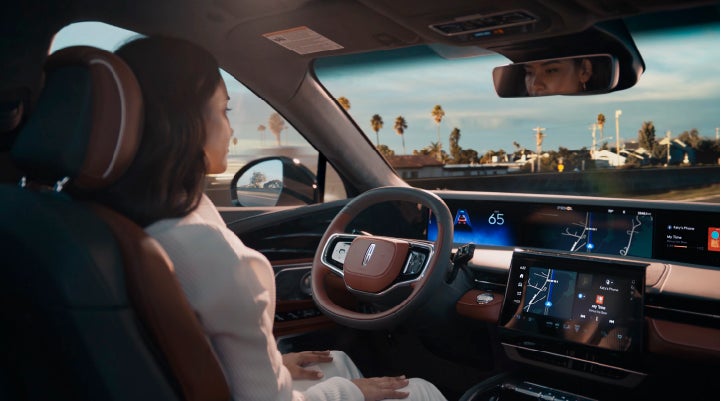 A person is shown driving hands-free on the highway with available Lincoln BlueCruise technology. | Buss Lincoln in McHenry IL