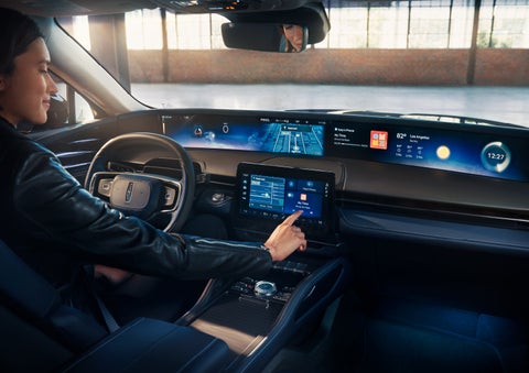 The driver of a 2024 Lincoln Nautilus® SUV interacts with the center touchscreen. | Buss Lincoln in McHenry IL